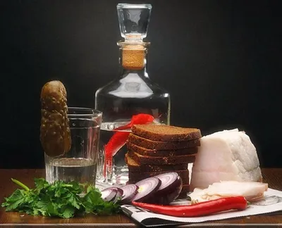 Vodka with various traditional snacks and appetizers: pickled cabbage,  cucumber, tomato, herring, lard, potato, sauce Stock Photo by ©kopachinsky  142651427